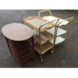 Two rectangular gilt metal trolleys, each with three tray shelves, having handles to each ends;