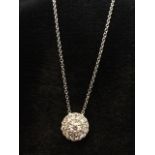 An 18ct white gold diamond cluster pendant, the circular panel set with two bands of diamonds