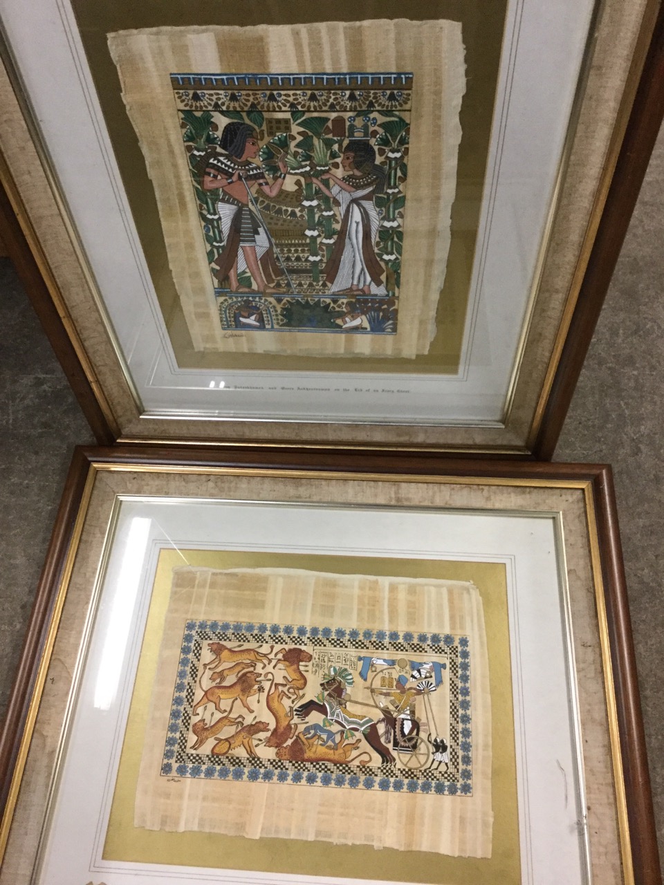 A pair of Egyptian papyrus style paintings, hunting lions and King Tutankhamen etc, the signed