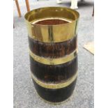 A nineteenth century oak brass bound stickstand of barrel form. (21.5in)