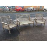 A set of teak garden chairs with chinese style fretwork panels to backs and platform arms on
