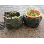 A pair of circular granite planters, the pots hewn out of rocks. (14in x 10.5in) (2)
