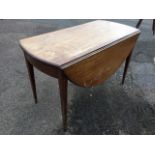 A nineteenth century mahogany pembroke table with two drop leaves forming a near circular, the