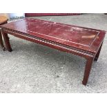 A rectangular 4ft hardwood coffee table with panelled top above moulded frieze, raised on tapering