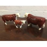 A graduated pair Beswick Hereford bulls with printed marks and painted Ch of Champions marks; and
