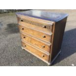 An oak chest of drawers, the rectangular top above four knobbed moulded drawers, the top drawer with