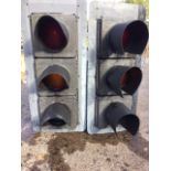 A pair of traffic lights with red, amber & green circular lenses in rectangular polyethylene frames,