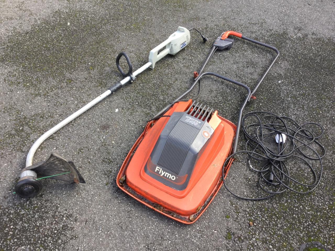 A Flymo electric Sprinter E400 hover mower with electric cable; and a Ryobi electric garden