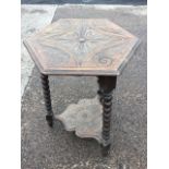 A Victorian carved oak hexagonal lamp table, the moulded top with scrolled acanthus carved medallion