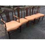 A married set of five Hepplewhite style mahogany dining chairs with carver, the shield shaped
