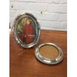 An oval scalloped hallmarked silver photograph frame on easel stand - Birmingham, 1939. (7in); and
