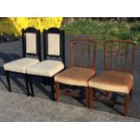 A pair of antique elm dining chairs with lathe backs above stuffover upholstered seats, raised on