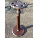 A nineteenth century mahogany snooker cue stand, the circular moulded top pierced with six