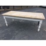 A large rough pine kitchen table with plank top on painted base with turned legs. (84in x 40in x