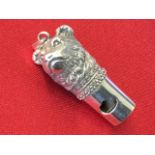 A silver whistle modelled as a bears head with beaded collar, mounted with ring hook - Sterling