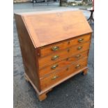 A George III mahogany bureau, with fallfront revealing an interior with nine small drawers and