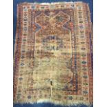 An antique oriental rug, the field with shaped panel centred by blue medallion, within a star border