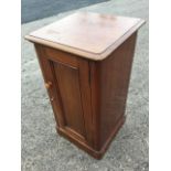 A Victorian mahogany washstand pot cupboard, the rounded moulded lifting top revealing a bowl with