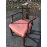 A Hepplewhite style mahogany armchair, the shield shaped back having pierced scrolled splat carved