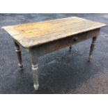 A nineteenth century farmhouse table with rectangular plank top above a deep frieze with knobbed