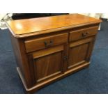 A Victorian mahogany side cabinet with rectangular rounded top above two frieze drawers and panelled