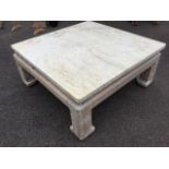 A limed oak coffee table, the square fossilstone marble top in scalloped frame, raised on square