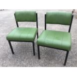 A pair of Godfrey-Syrett childrens chairs with upholstered seats and backs on square metal