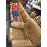 A 60s Tetrad tan leather three piece suite with swivel armchair, a two seater sofa and a single