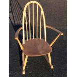 An Ercol rocking chair with hooped spindleback above an elm seat, raised on turned legs & stretchers