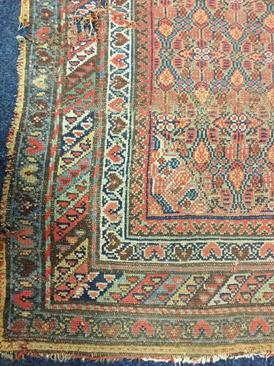 An antique Indian runner, the field woven with two lozenges in floral grid on madder ground, - Image 3 of 3