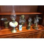 Six oil lamps - handpainted ceramic, glass, brass, hanging, etc; and two brass blowlamps. (8)