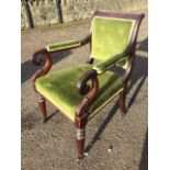 A Victorian mahogany elbow chair, having button upholstered back with scrolled carved arms, the