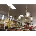 A Dutch style brass chandelier with five scrolled branches holding candlelights around a bubous