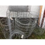 A quantity of galvanised pig wire fencing with square apertures - six rolls; a small roll of