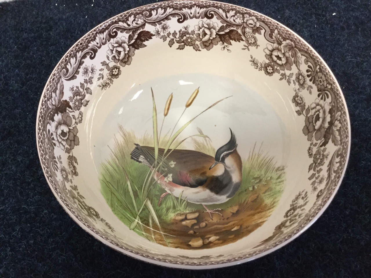 A nineteenth century Davenport plate painted with a country river landscape scene, with floral - Image 2 of 3
