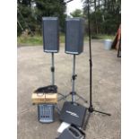 A Kustom Profile PA system with pair of line array speakers on adjustable tripod stands, an