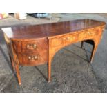 A Georgian mahogany sideboard of breakfront outline, the top inlaid with chequered stringing above a