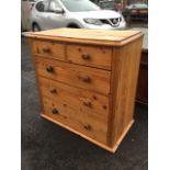 A Victorian pitch pine chest of drawers, the rectangular top with moulded edge above two short and