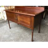 A late Victorian mahogany washstand with rectangular moulded top above panelled doors, raised on