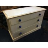 A Victorian painted pine chest of three long knobbed drawers, with rectangular moulded top and