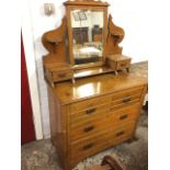 An Edwardian satin walnut dressing table with bevelled mirror on shaped supports with crescent