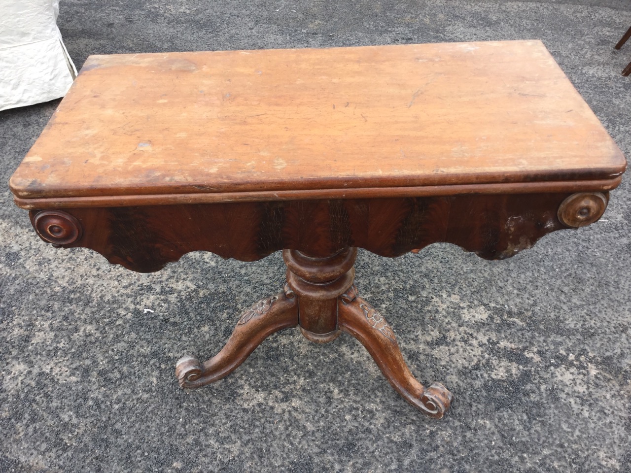 A Victorian mahogany turn-over-top tea table, the rounded twin top above a shaped apron with applied