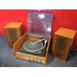 An Audiotrine A55 1970s teak cased record player with two ribbed speakers, having Garrard deck under