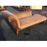 A Victorian carved oak chaise longue, with rectangular sprung seat and padded back, with scrolled
