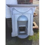 A painted cast iron fireplace with mantelpiece above a bead swagged panel and domed hood. (34.25in x