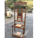 An Edwardian oak hallstand, the back mounted with pegs having turned gallery spindles above a
