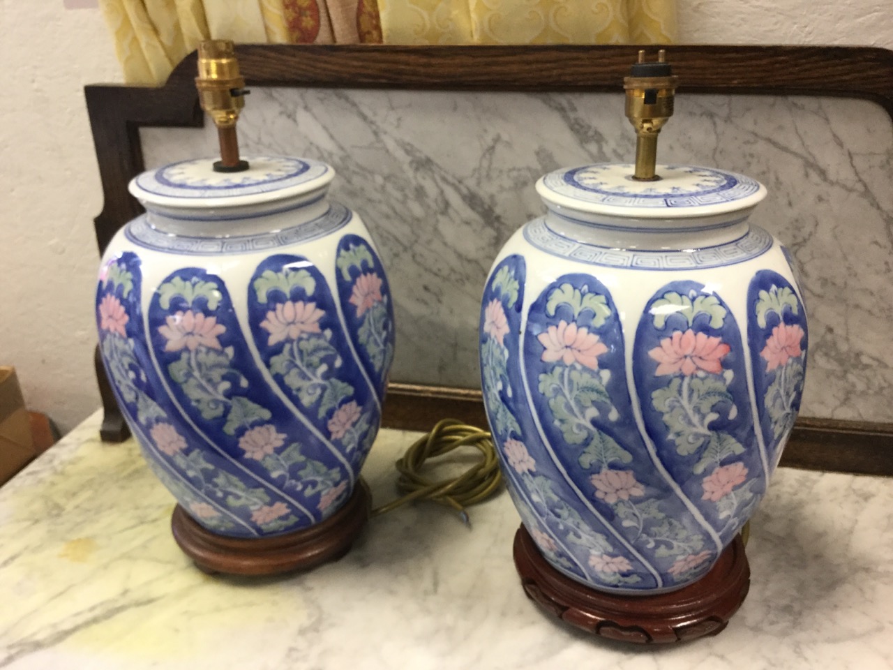 A pair of contemporary chinoiserie tablelamps with pink floral gadrooned moulded jars beneath blue &