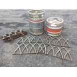 A set of eleven wrought iron garden border protectors of arched gothic design on spear supports; and