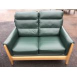 A contemporary leather Clintique two-seater sofa, with panelled loose cushions and sprung seat in an