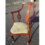 An Edwardian mahogany corner armchair, the back inlaid with boxwood stringing having central vase